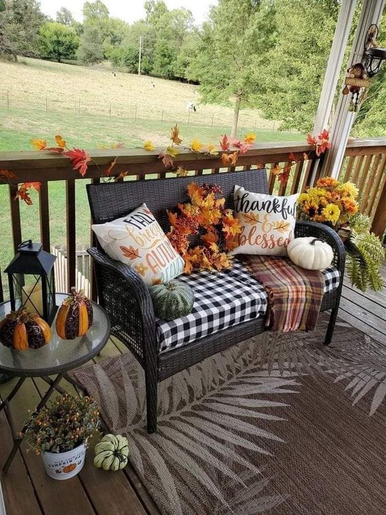 Cozy Fall Porch With Pillows and Pumpkins