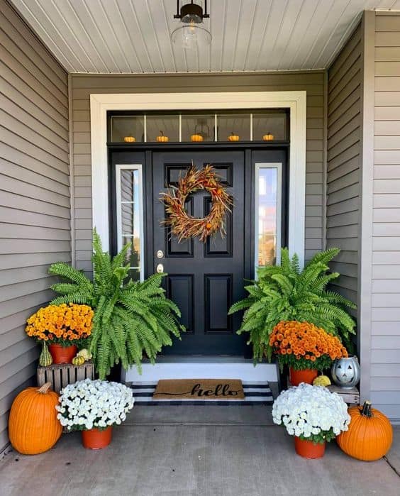 Welcoming Fall Porch with Mums, Ferns, and Pumpkins