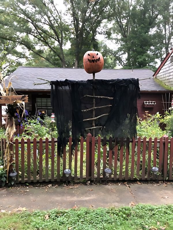 Giant Pumpkin-Headed Scarecrow Fence