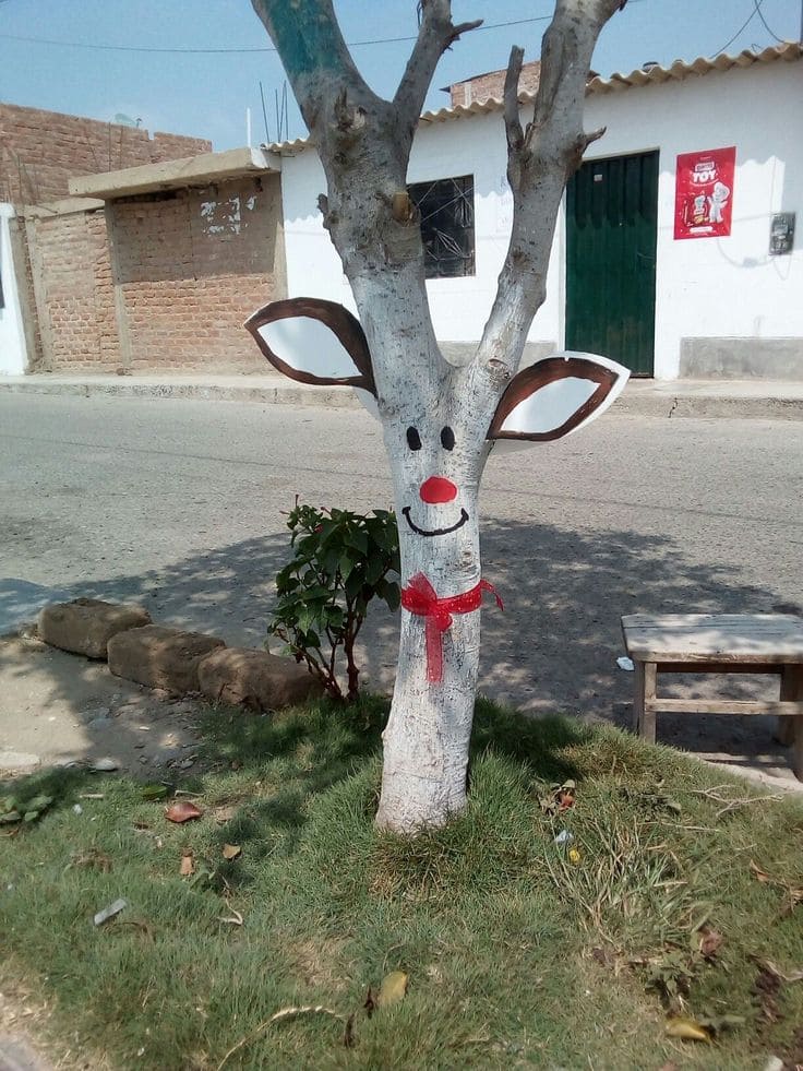 20 Whimsical Tree Trunk Projects That Transform Your Outdoor Space Painted Reindeer Tree Trunk