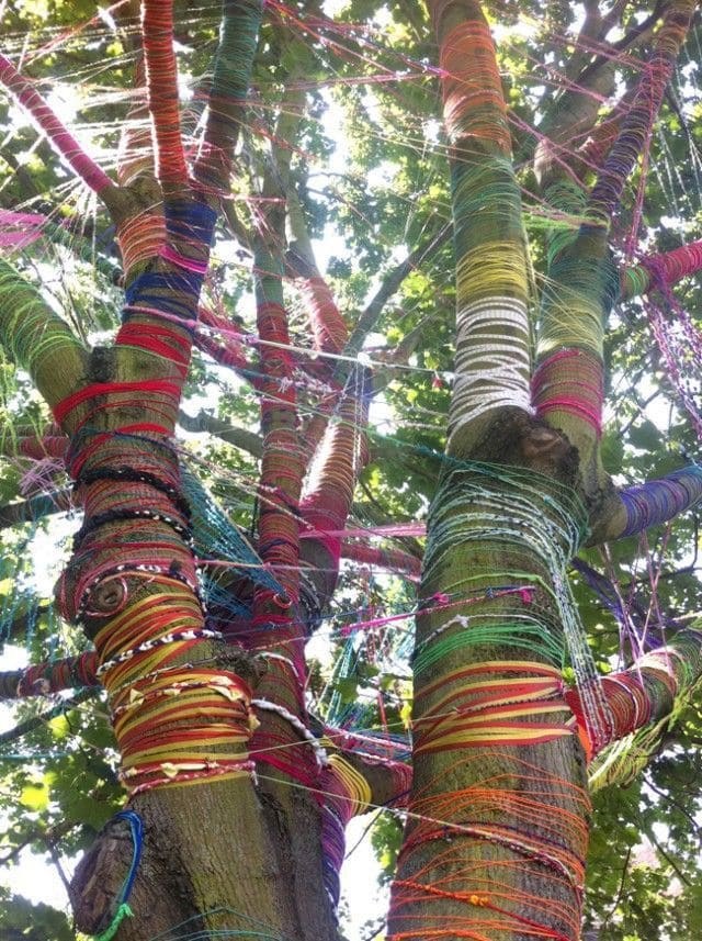 20 Whimsical Tree Trunk Projects That Transform Your Outdoor Space Yarn-Wrapped Tree