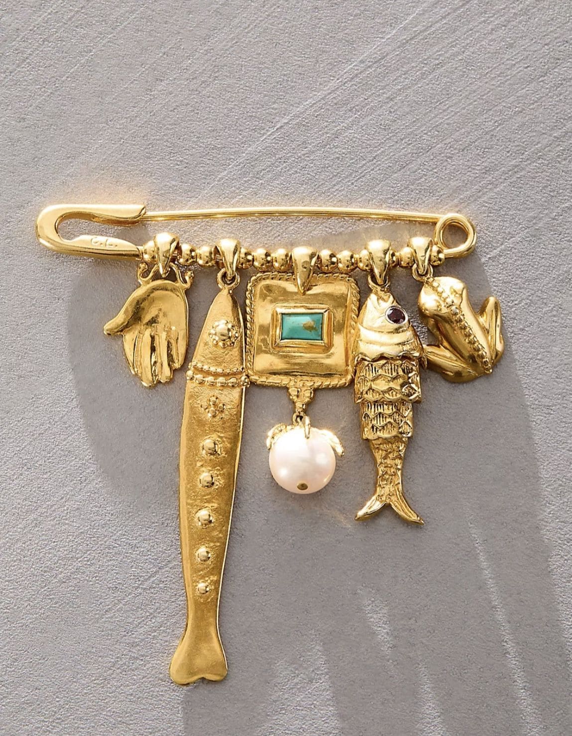 Golden Charm Brooch with Whimsical Motifs