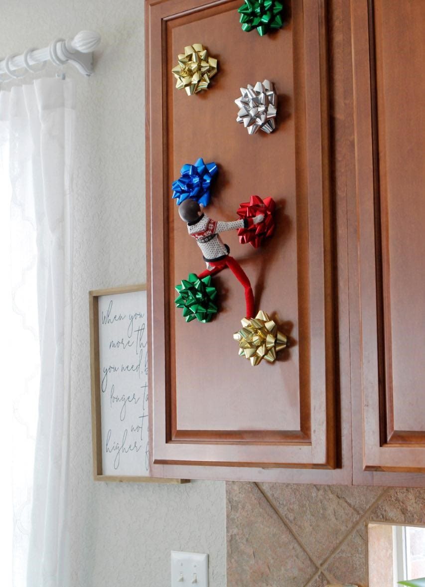 25 Hilarious Elf on the Shelf Ideas Crack Up the Whole Family Elf the Gift Bow Climber