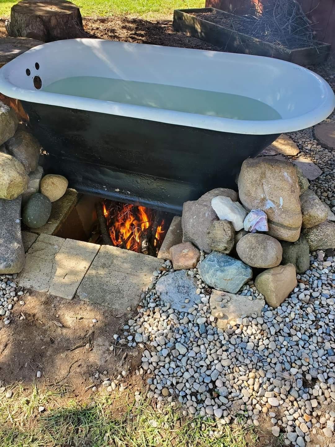 20 Outdoor Hot Tub Setups That Redefine Home Relaxation Rustic Fire-Heated Tub Haven