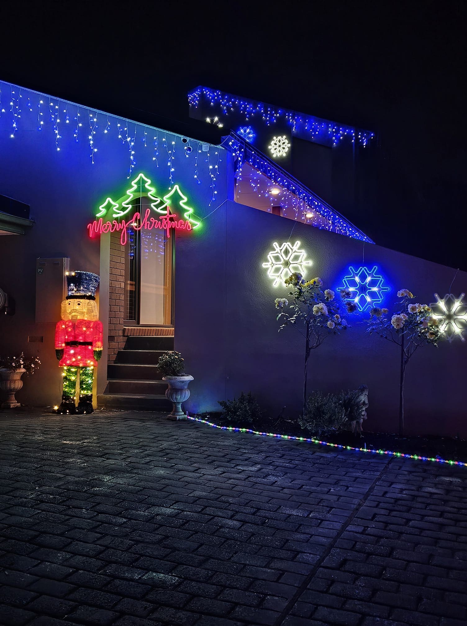20+ Christmas Driveway Ideas for a Magical Holiday Arrival Neon Snowflake Holiday Entrance