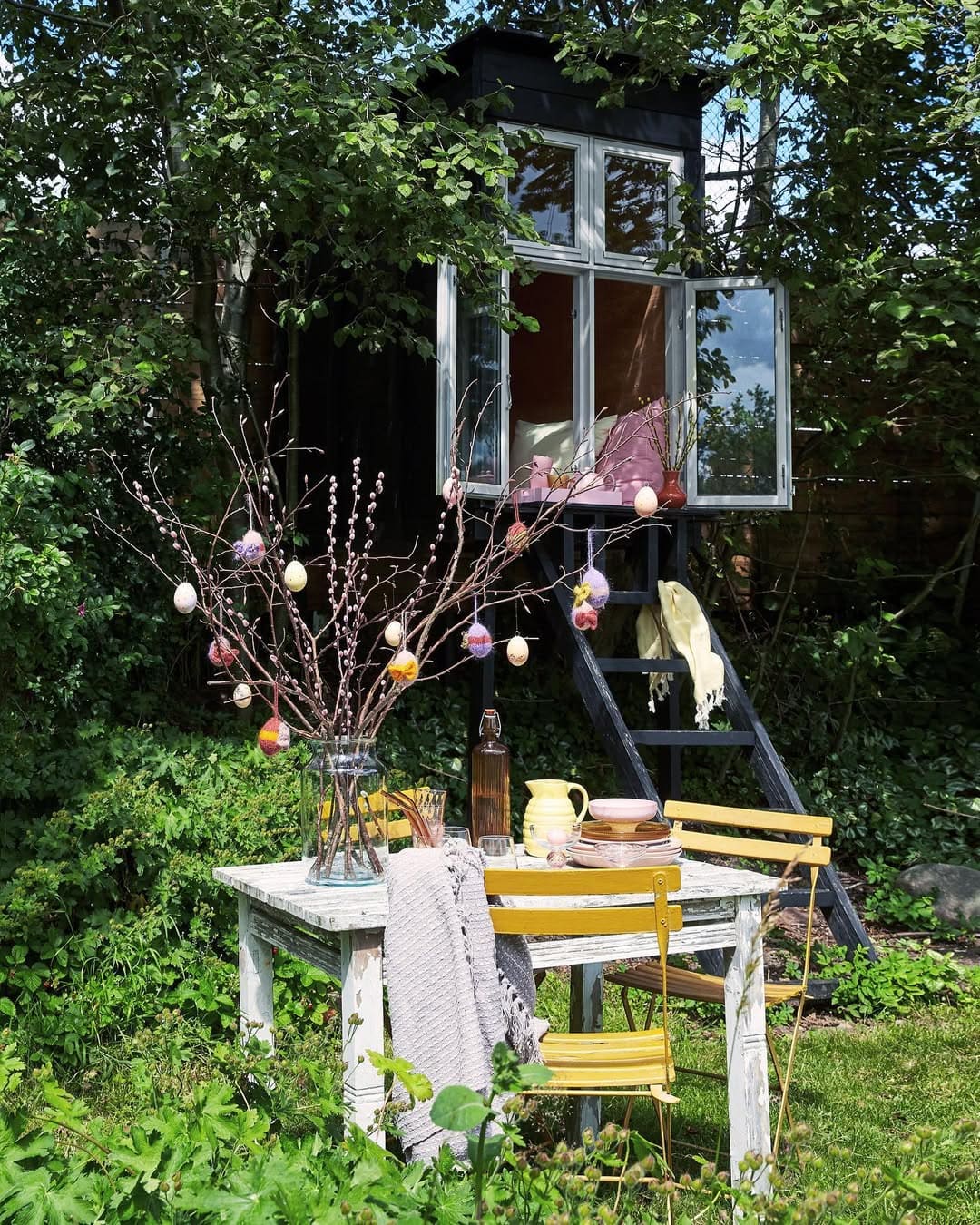 20 Easter Yard Decor Ideas to Create a Memorable Celebration Garden Table With Hanging Egg Branches